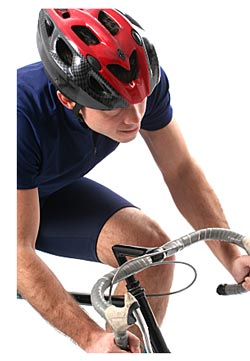 man wearing helmet riding bicycle