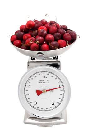weighing cherries on kitchen scal