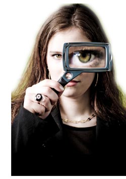 woman looking through a magnifying glass