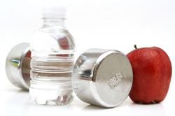 water bottle, dumbbell and and apple