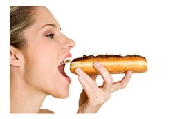 woman eating a large doughnu