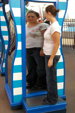 woman looking into distorted mirror