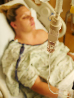 woman in hospital bed with intravenous (iv)