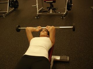 woman doing lying triceps extension second position