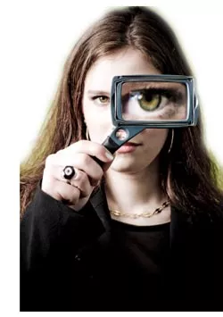 woman looking through a magnifying glass
