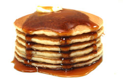 large stack of pancakes with syrup