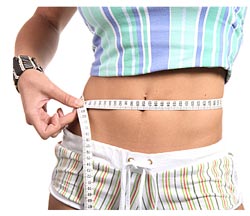 woman measuring waist with tape measure